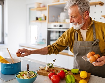 Dentures patient in Morgan Hill preparing food