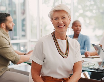 Dentures patient in Morgan Hill talking to coworkers