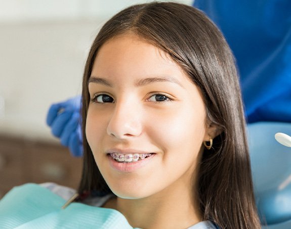 A young teen girl with braces in a dental clinic
