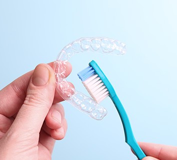 Patient cleaning clear aligner with toothbrush