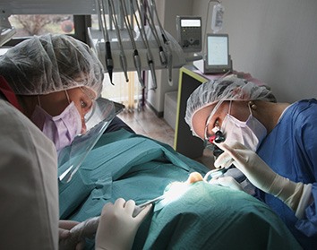 a dentist placing a dental implant