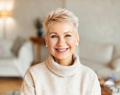 Senior woman in white sweater smiling