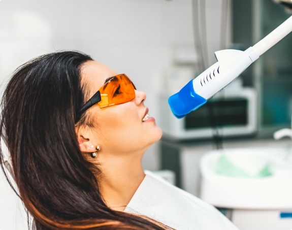 Woman receiving teeth whitening treatment