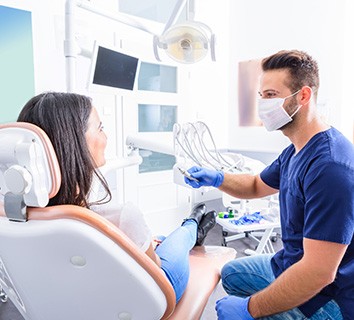 Dentist and patient talking in dental office