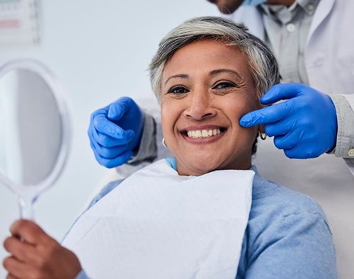 Smiling mature woman in dental treatment chair