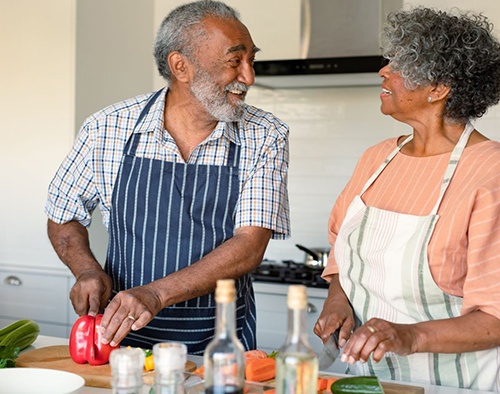 Happy older couple preparing a meal together