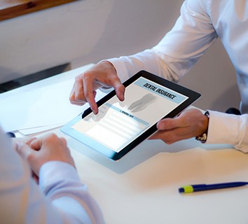 Patient reviewing dental insurance information on tablet