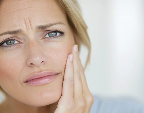 Worried woman touching the side of her face